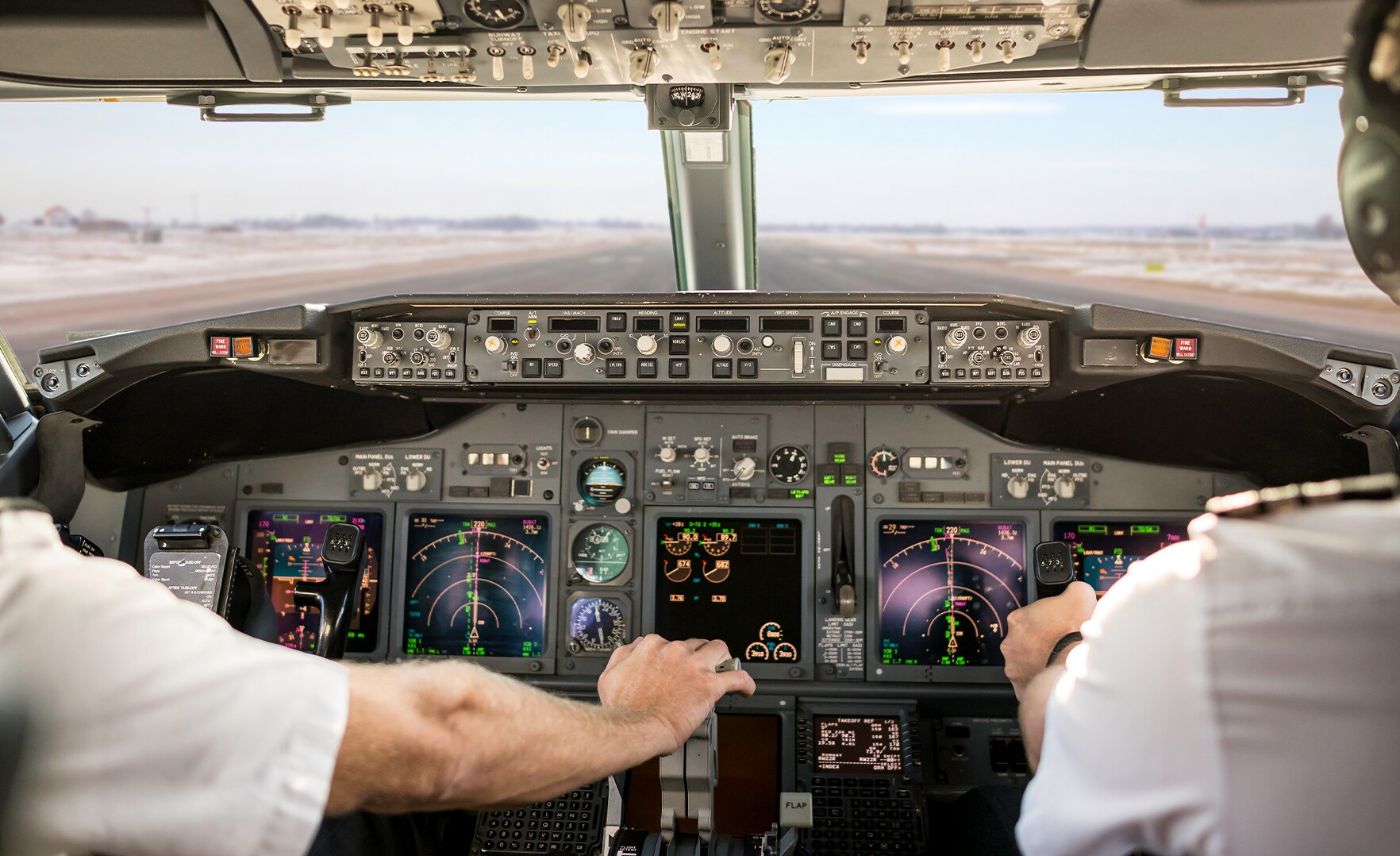 Cockpit of commercial plane with pilot/co-pilot.